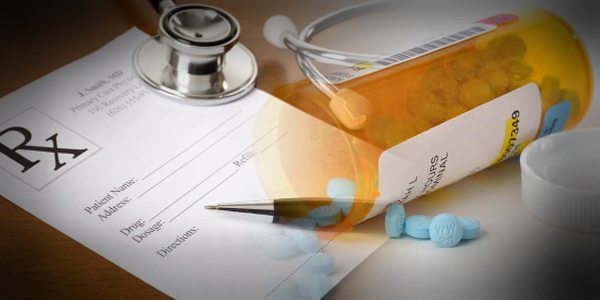 Bottle of pills on prescription sheet