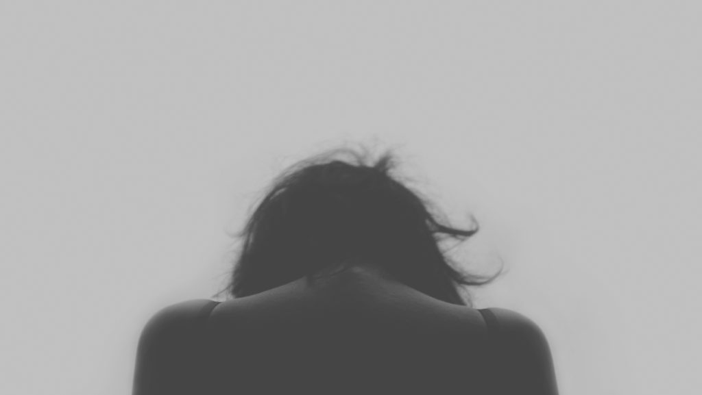 Woman with head down