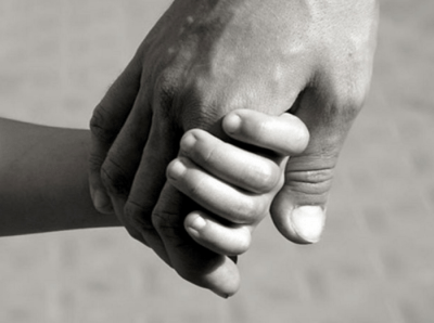 Adult and child hand holding