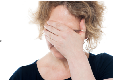 woman grasping face