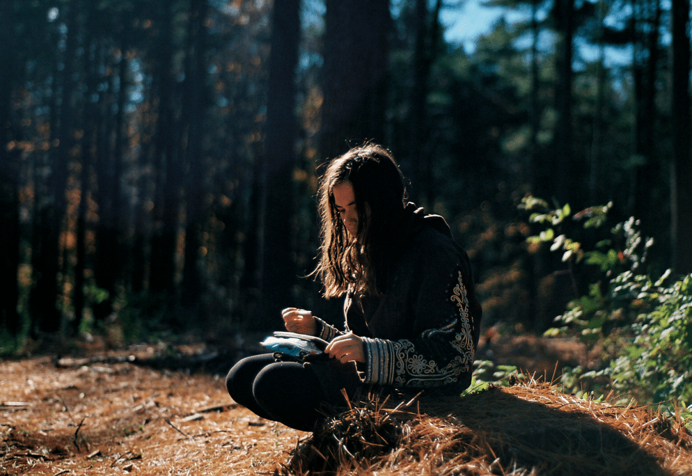 Young girl sitting in woods