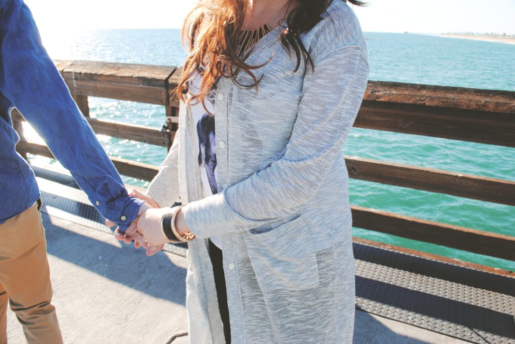 Woman standing on ocean pier