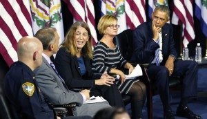 President Barack Obama, right, as Secretary of Health and Human Resources, Sylvia Burwell, center, speaks during an event at the East End Family Resource Center in Charleston, WVa., Wednesday, Oct. 21, 2015. Also attending the event is Charleston police chief, Brent Webster, left, Dr. Michael Brumage, second from left, and Cary Dixon, second from right. (AP Photo/Steve Helber)