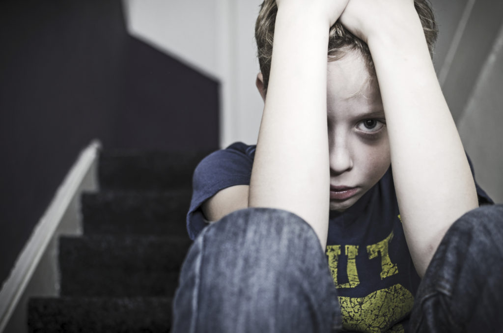 Scared boy on steps