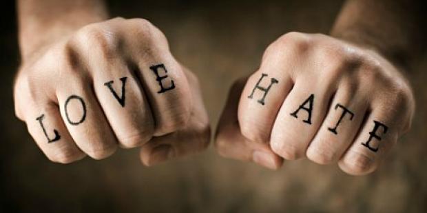 Love and hate written on fists