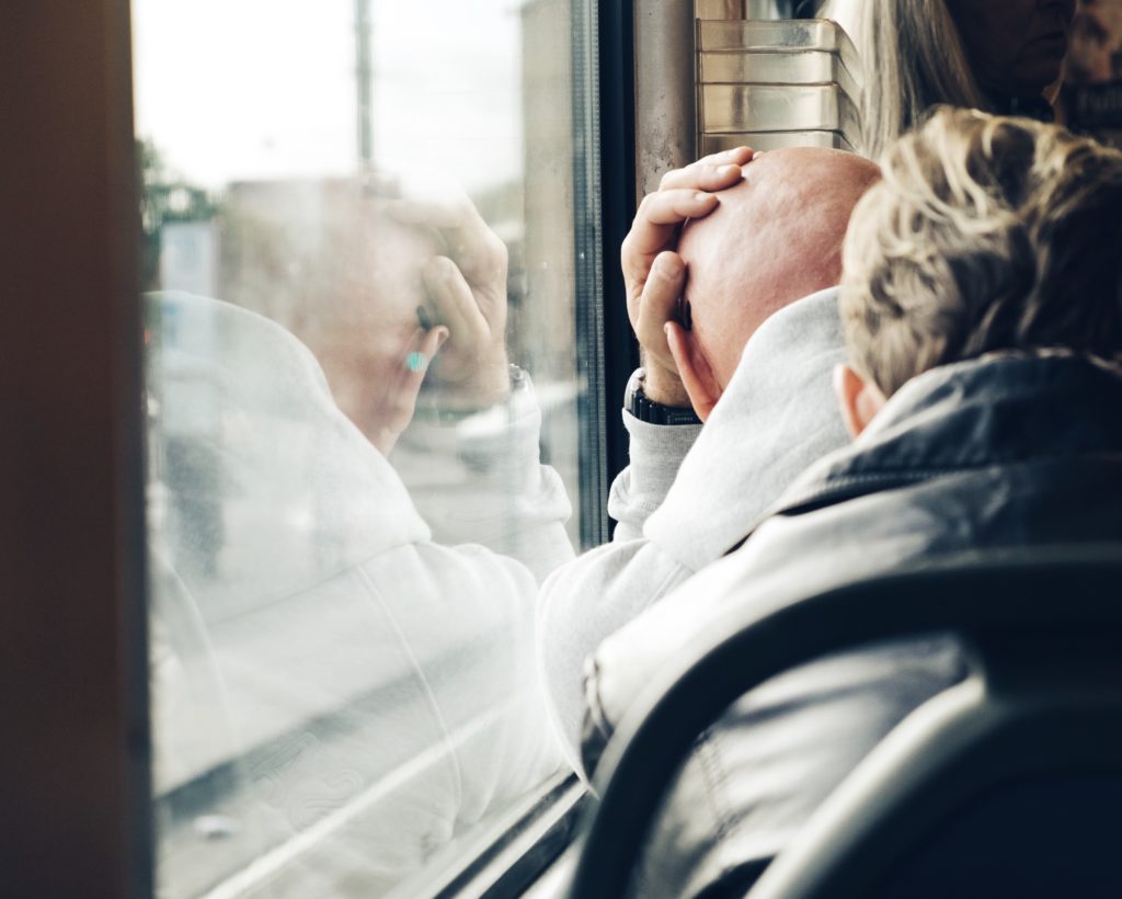 Man leaning against window
