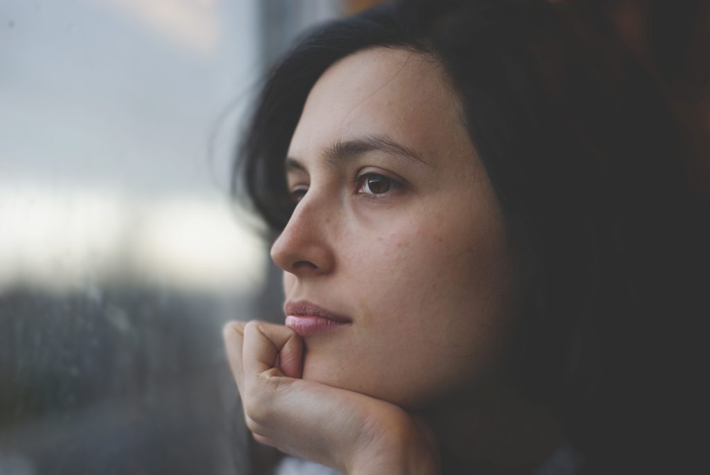 Sad woman looking out window