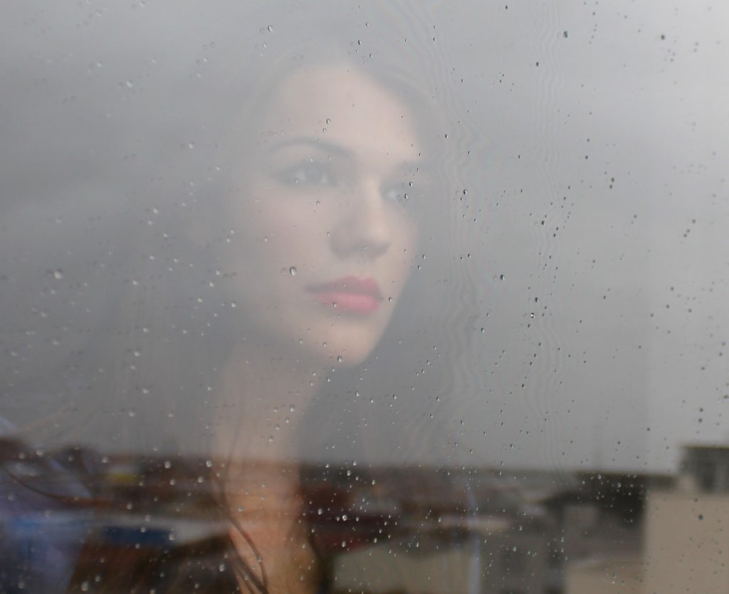Woman looking through window