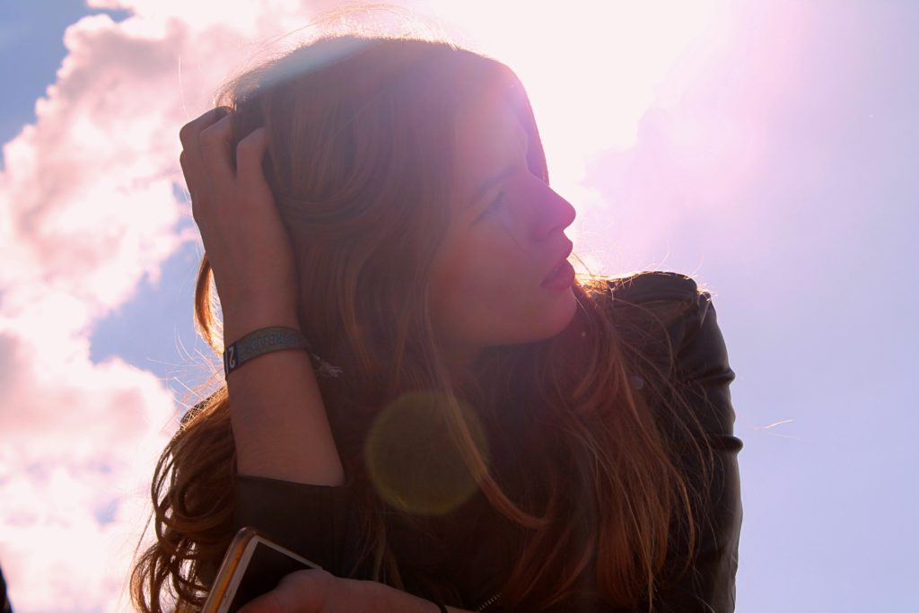 Woman with hand holding the back of her head