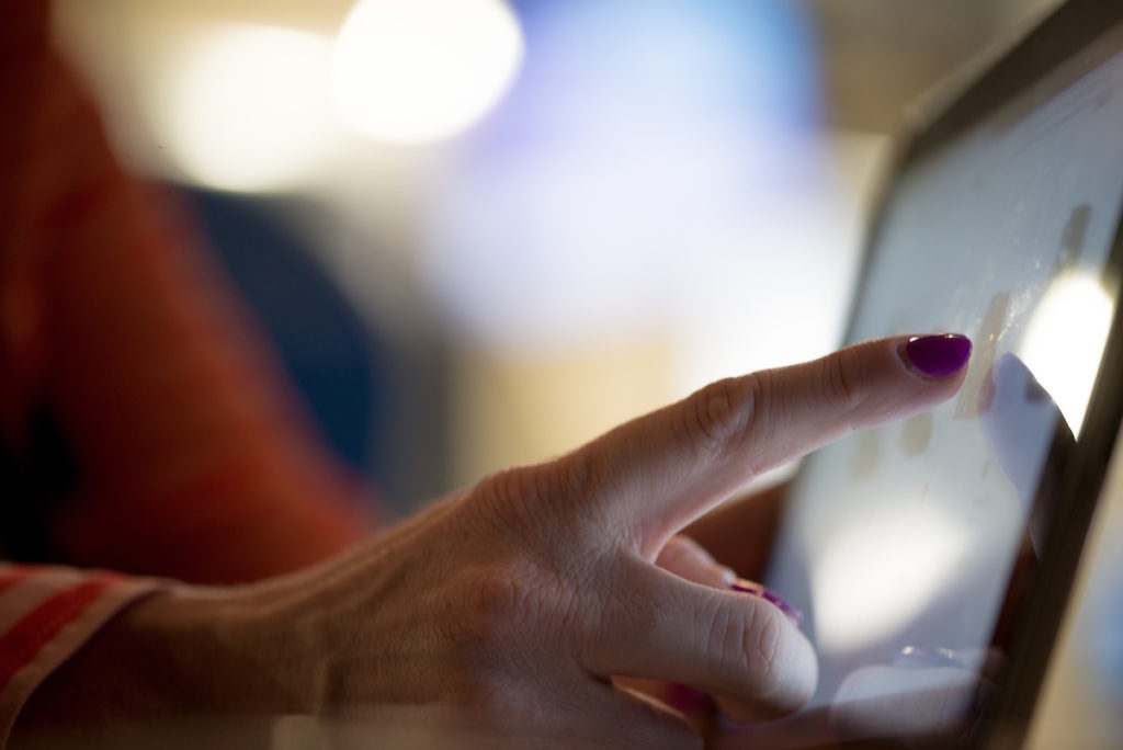 Woman's finger using tablet