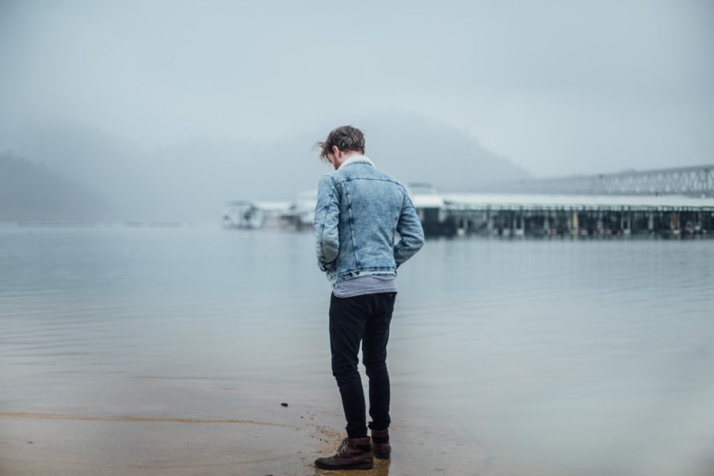 Man walking along water's edge