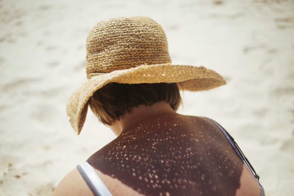Woman wearing sunhat near the water