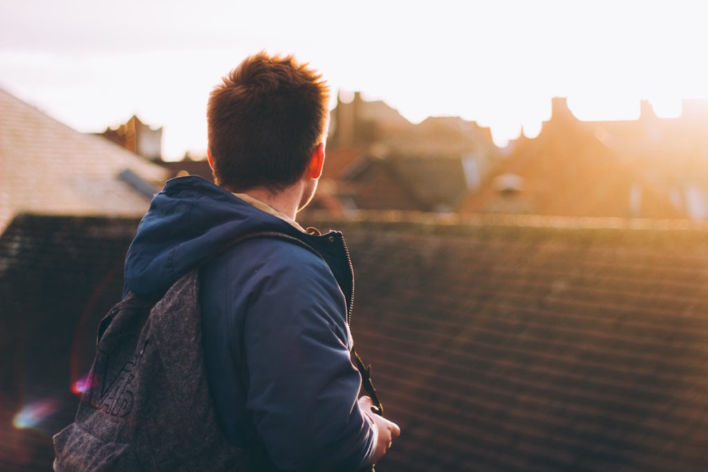 Man with backpack looking away