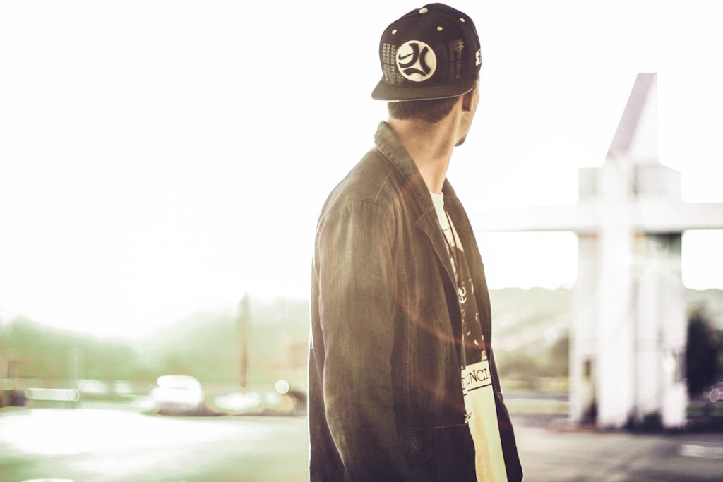 Young man wearing backwards hat facing away