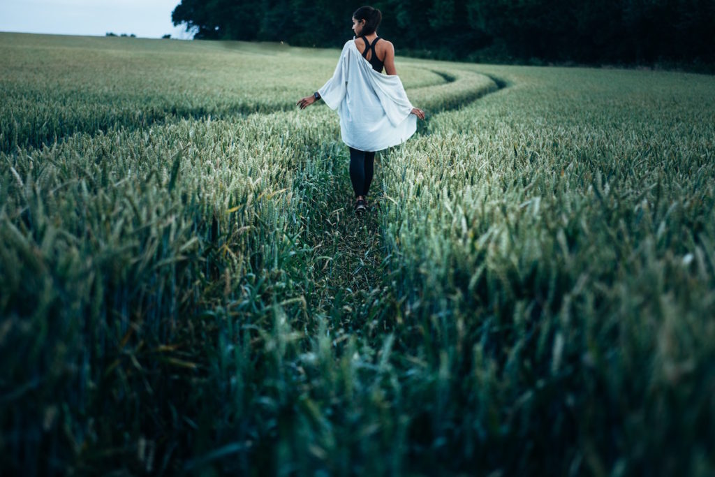 Woman walking through field