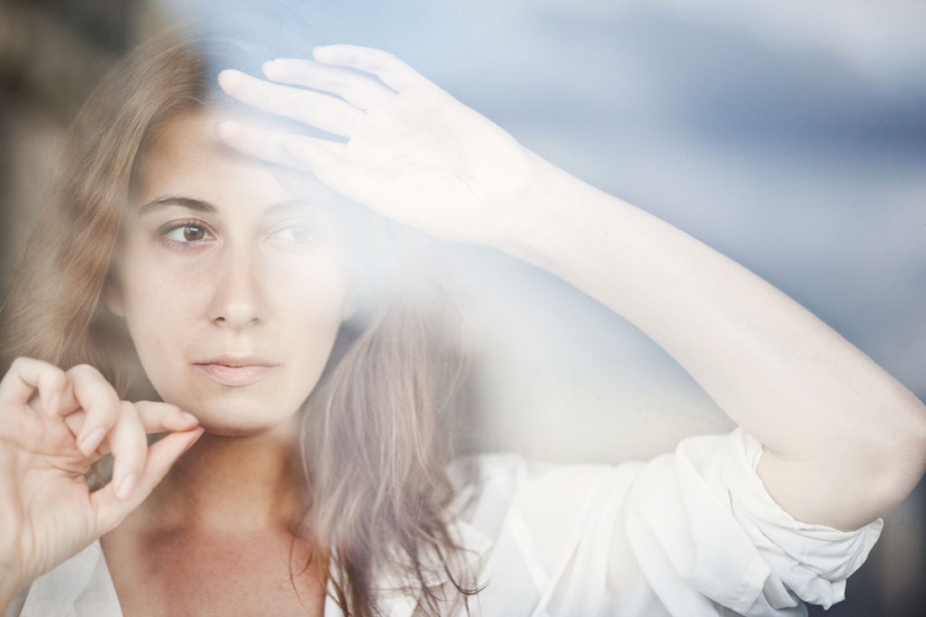 Woman looking out window