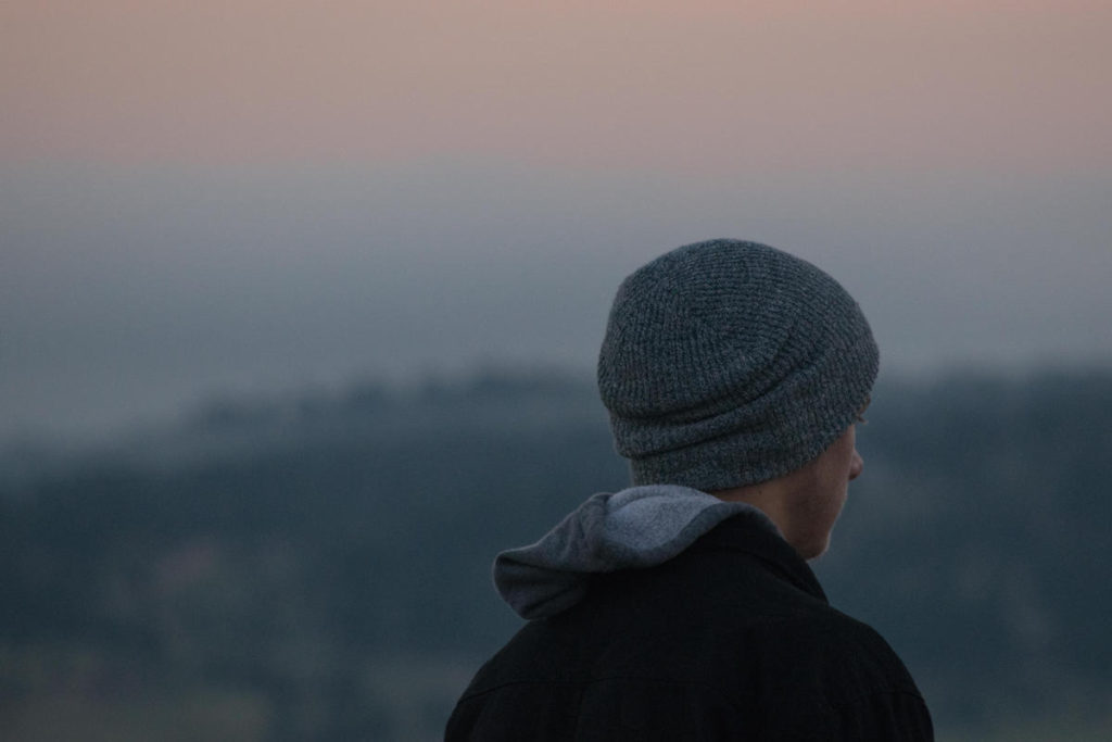 Man wearing hat facing away