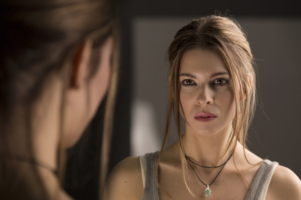 Woman looking at herself in the mirror