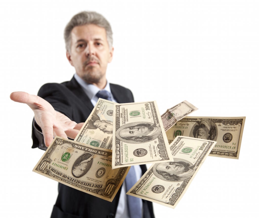 Man throwing $100 bills