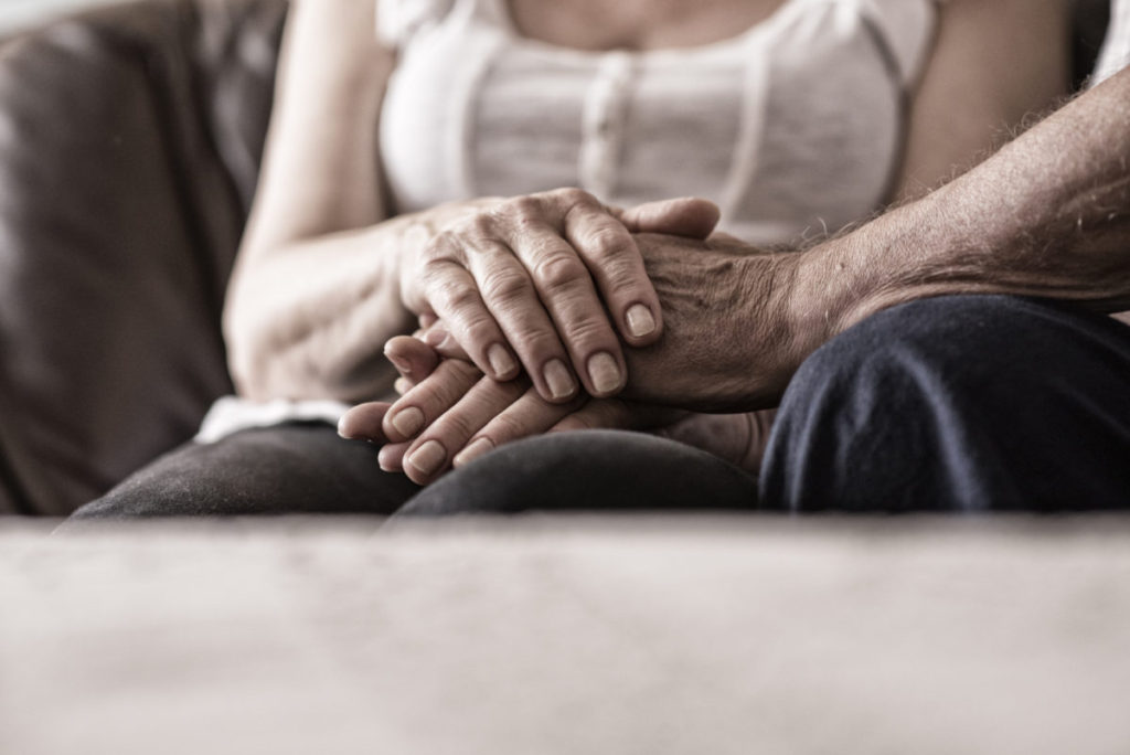Male and female holding each other's hands