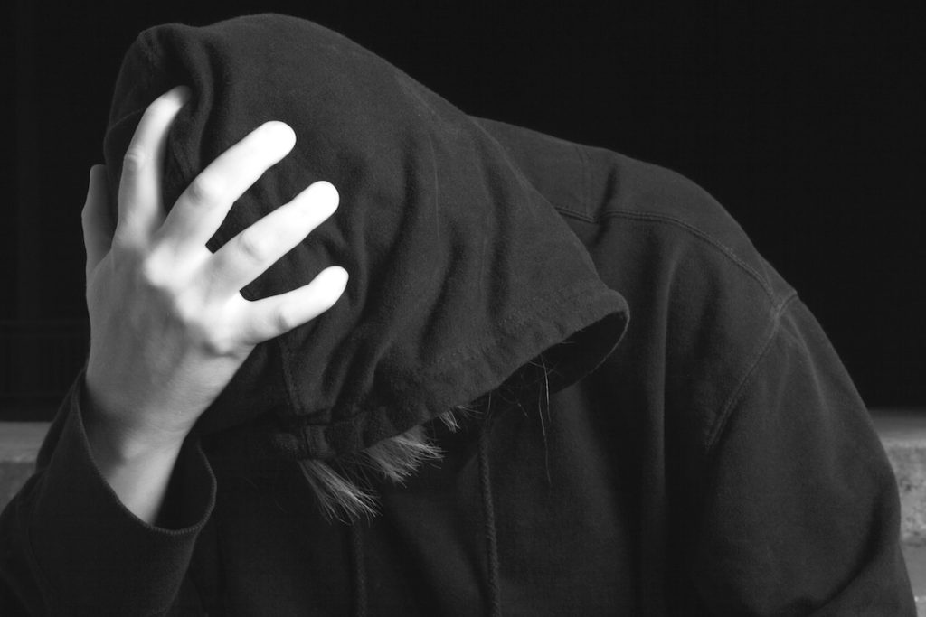 Man wearing hoodie and looking down