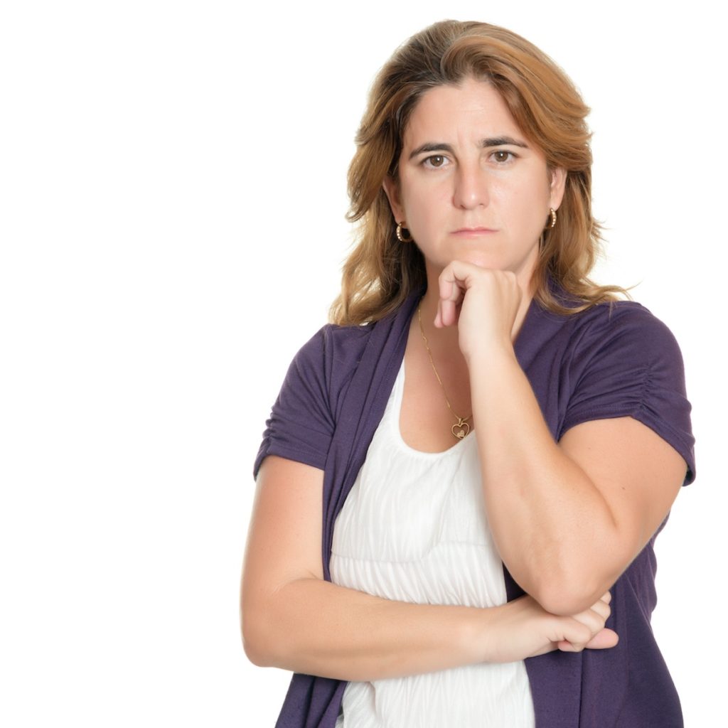 Serious woman with arms crossed and hand on chin