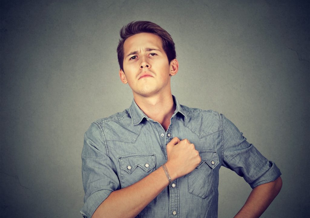 Man with fist on chest