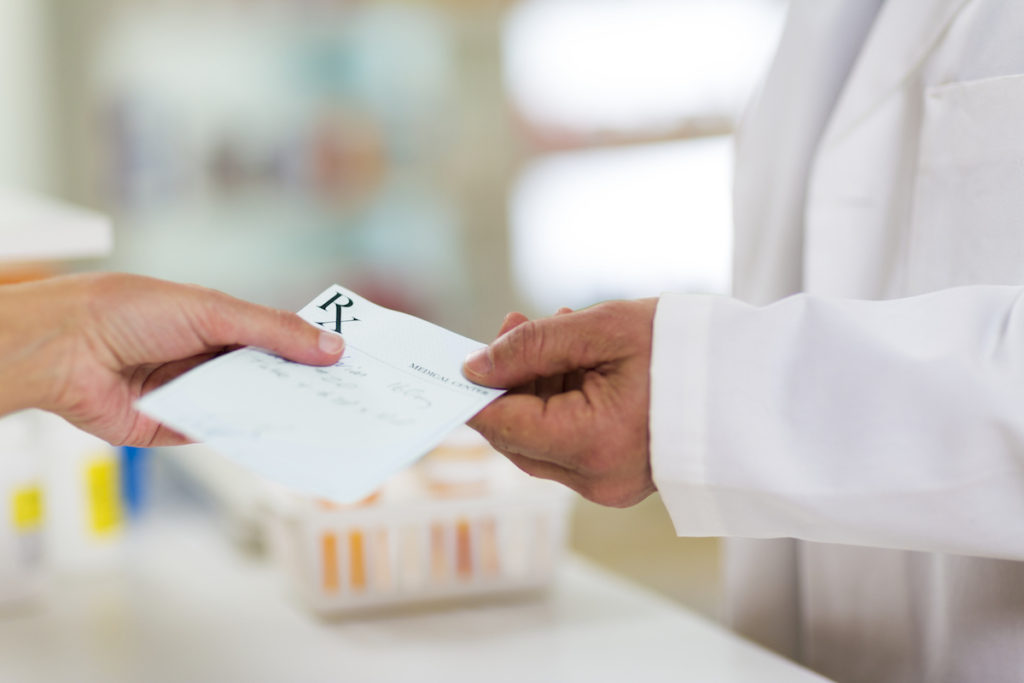 Doctor handing over a prescription