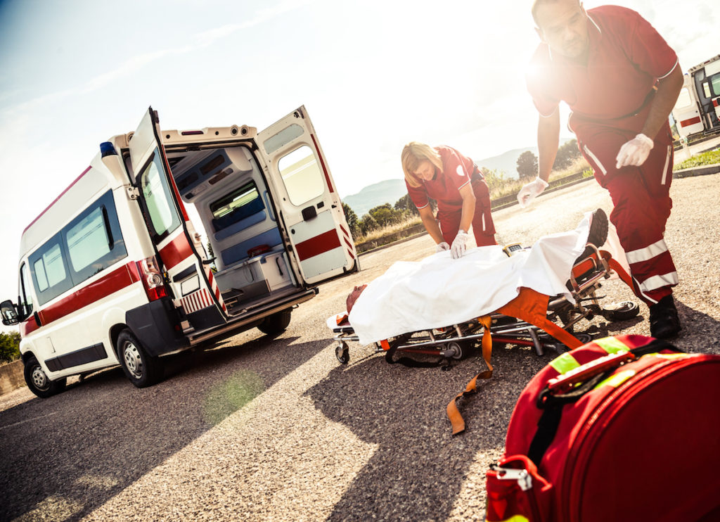 Paramedics and patient on stretcher outside of ambulance