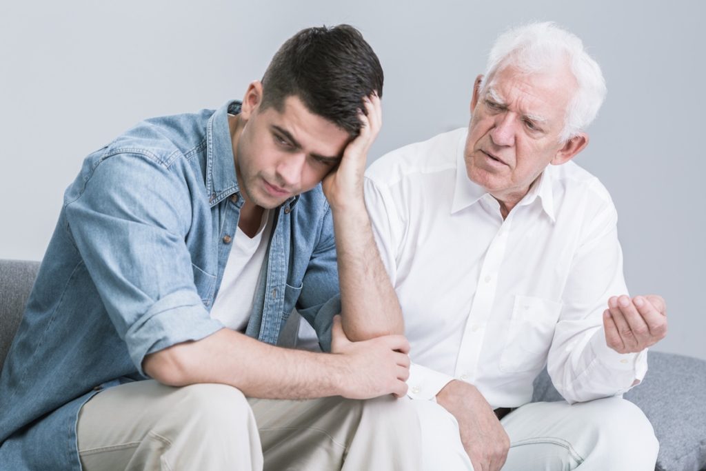 Grandfather talking to upset son