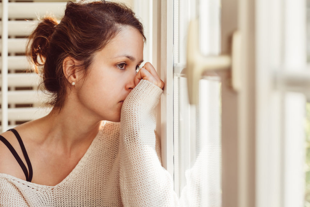 Sad woman looking out window