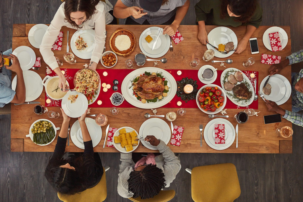 People sitting around Thanksgiving table