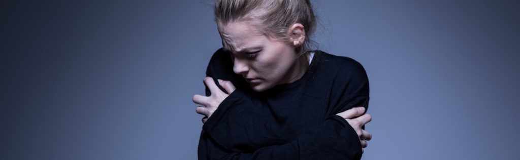 Distressed woman with arms crossed
