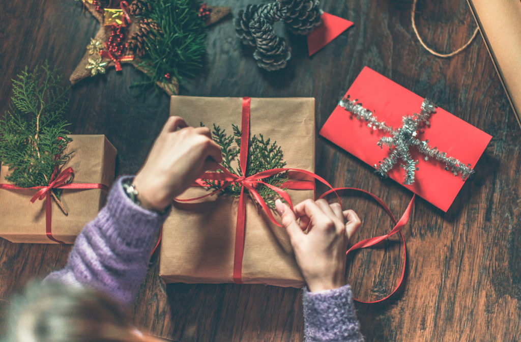 Woman's hands wrapping a Christmas Present