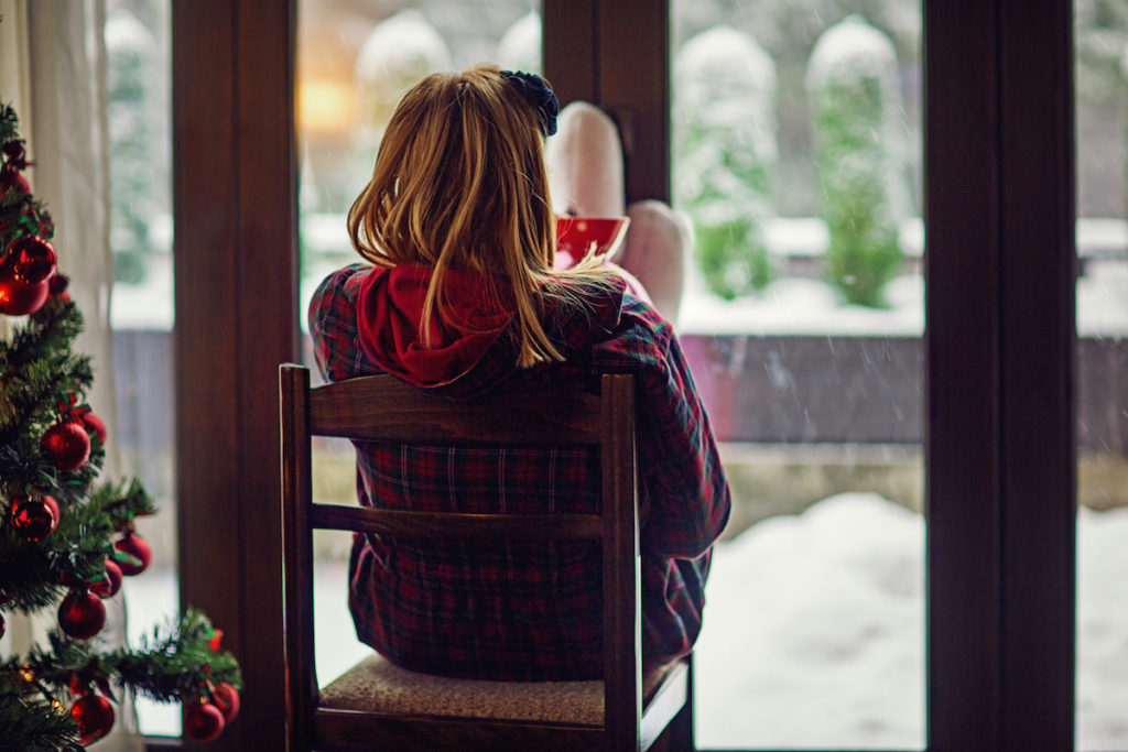 Woman's back sitting in chair during Christmas seaons