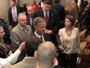 man speaking to press