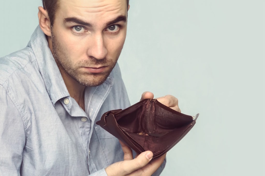 Man showing empty wallet
