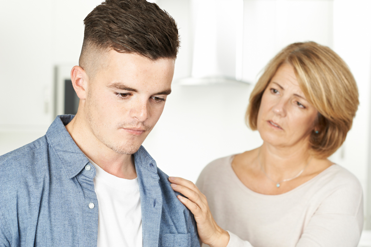 Sad mother looking at sad son