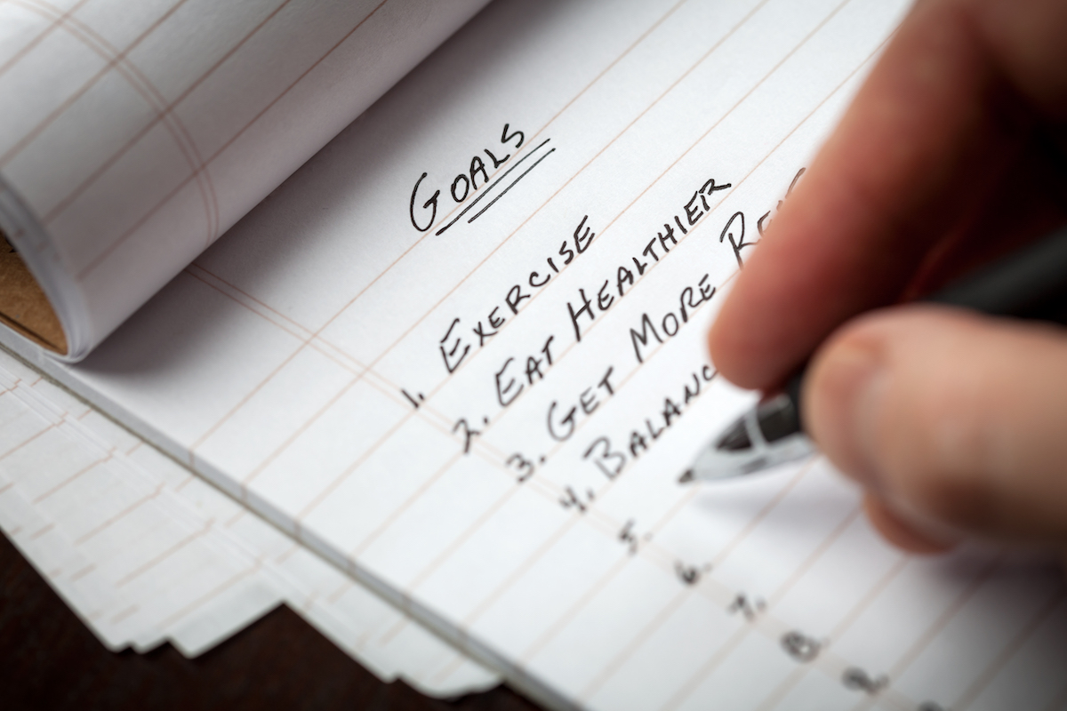 Hand writing a list of goals
