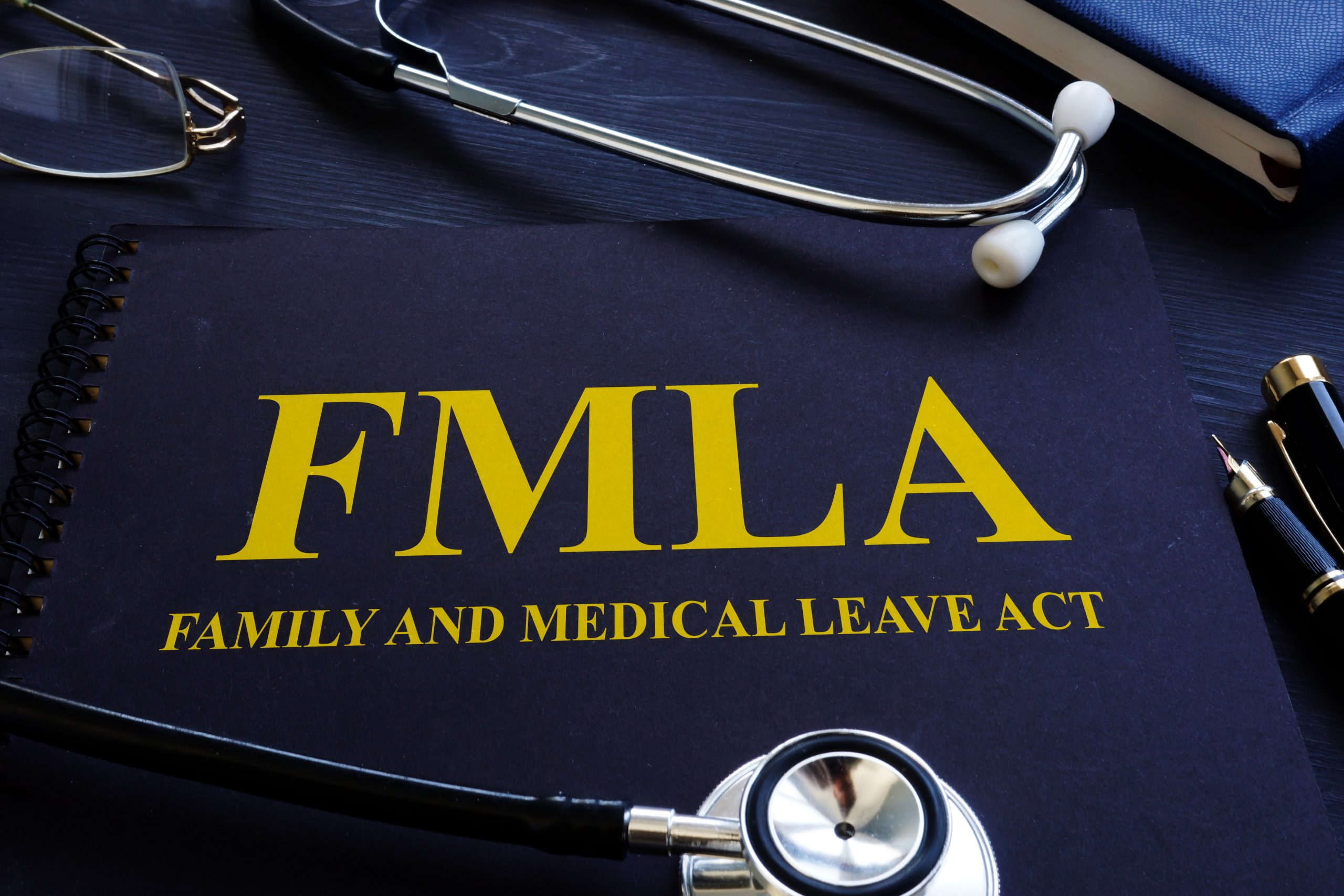 Family and Medical Leave Act notebook and stethoscope