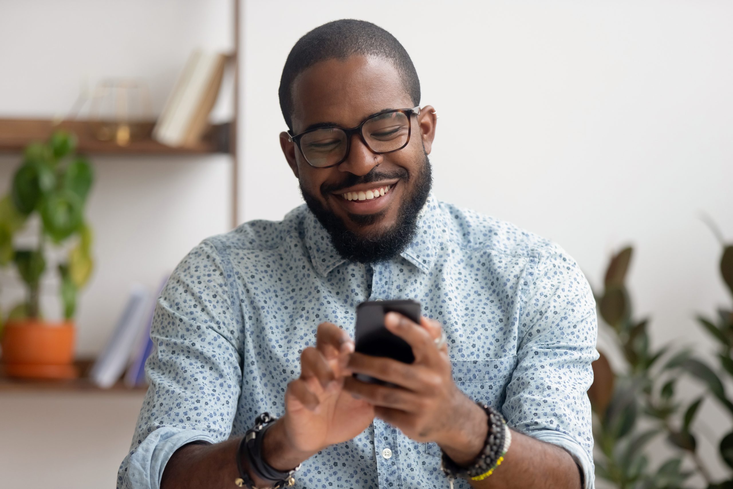 Man smiling and holding phone