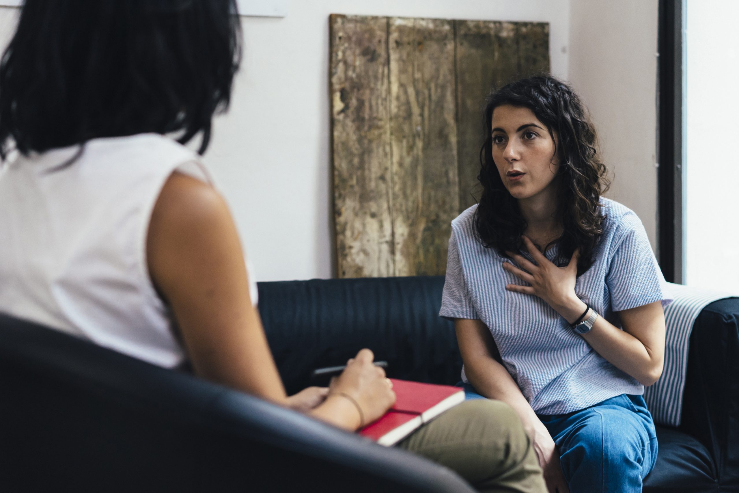 Woman speaking to therapist on couch