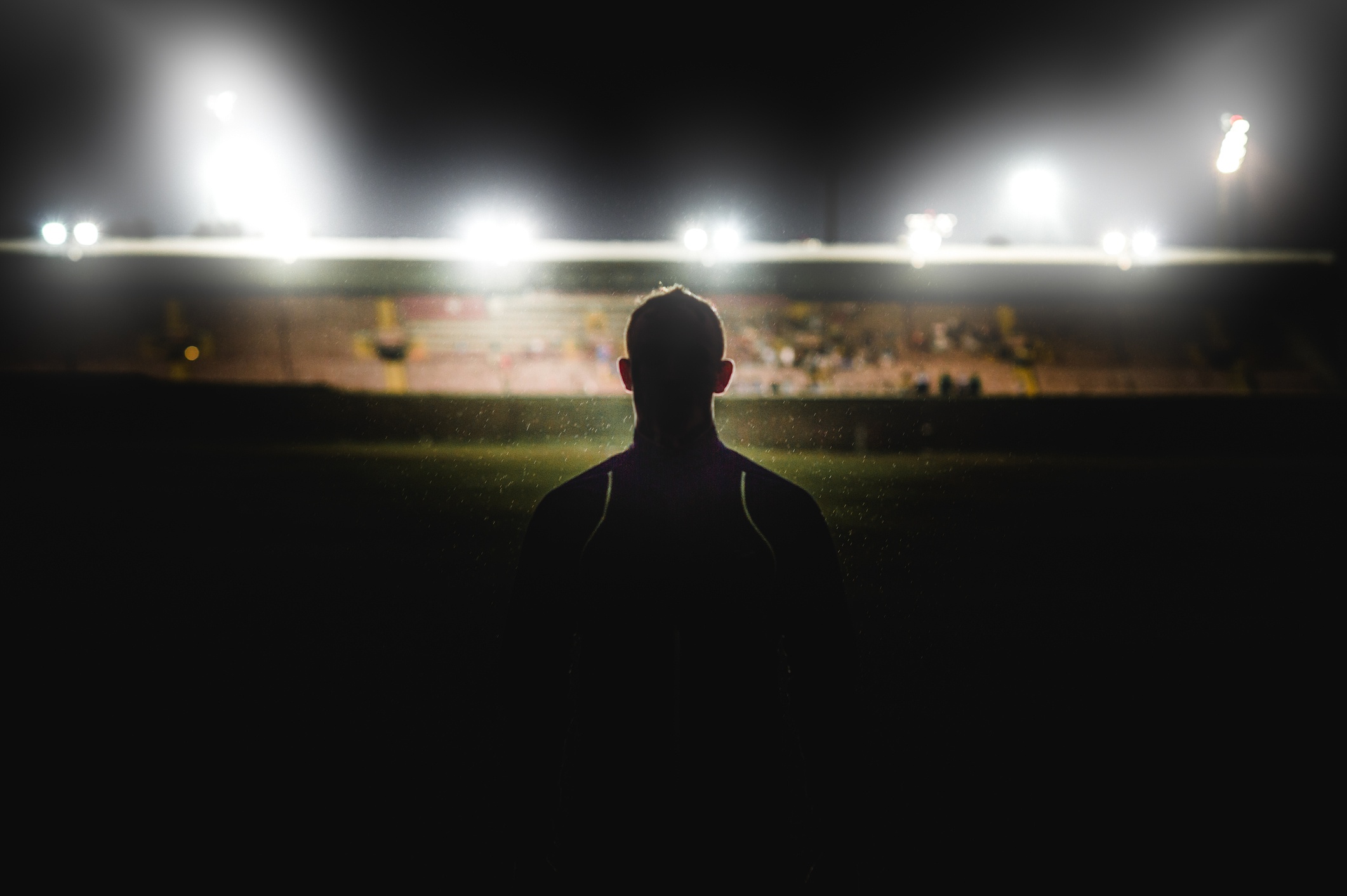 Silhouette of athlete walking towards stadium