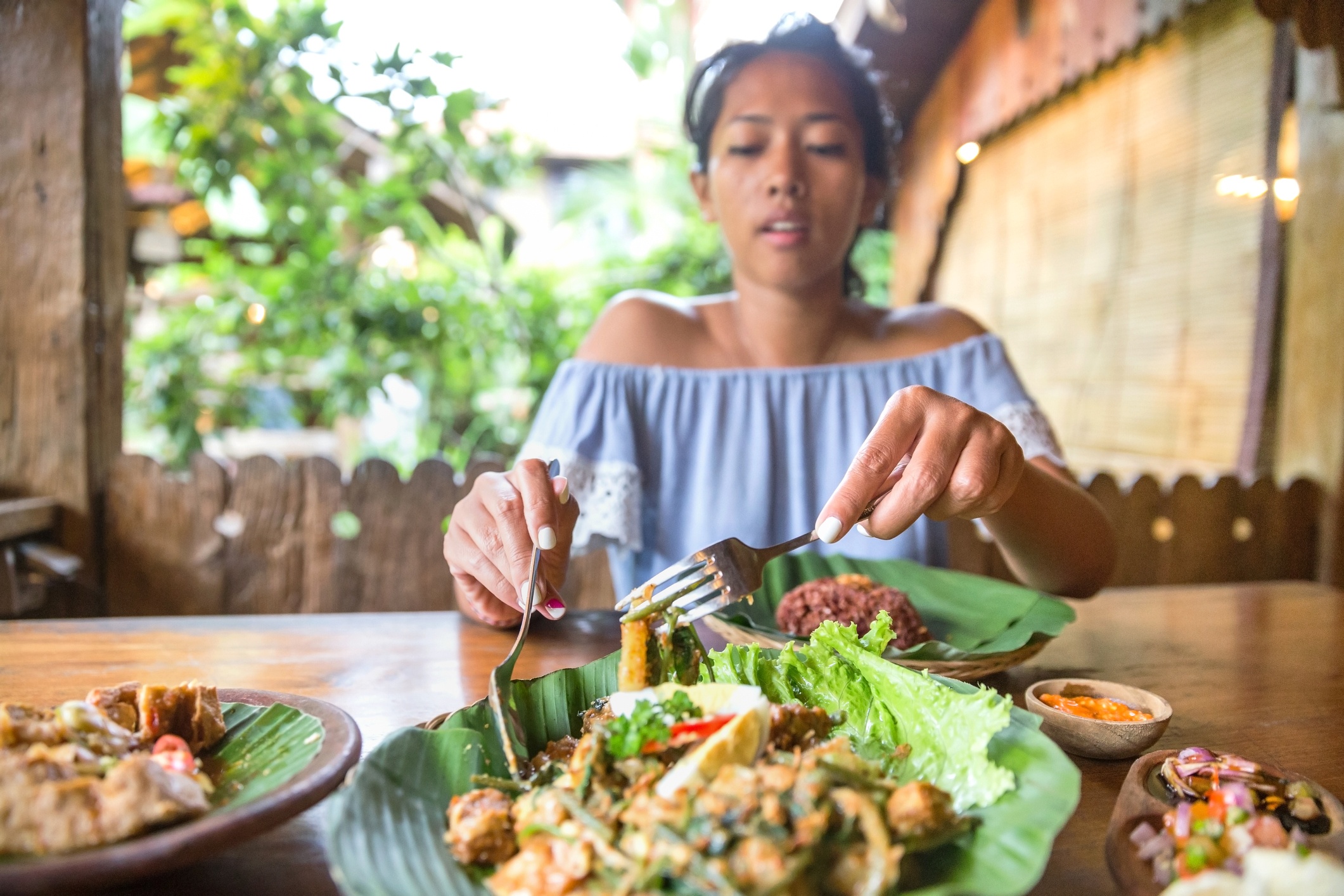 Woman preparing veggie wrap