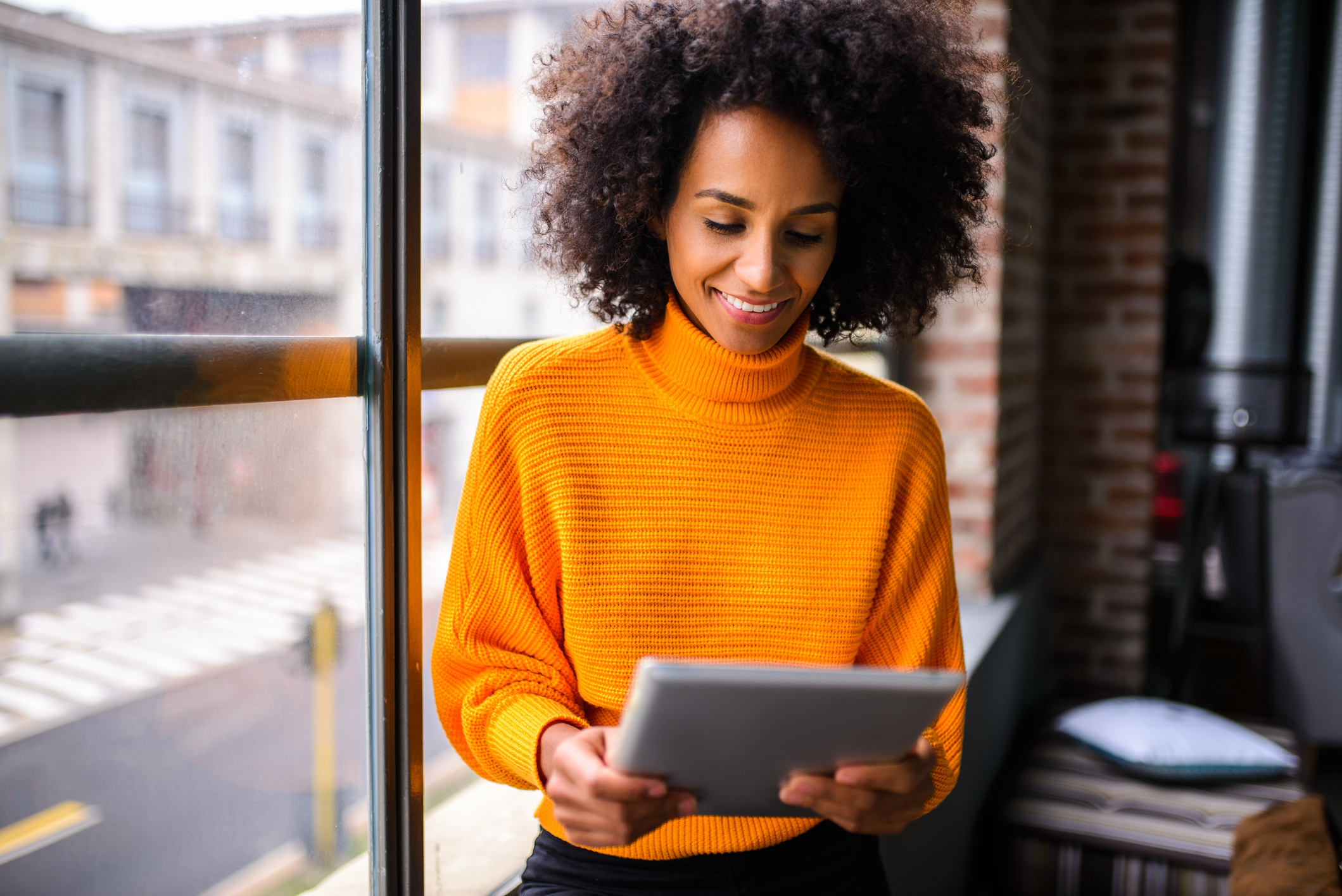 Woman smiling using digital tablet
