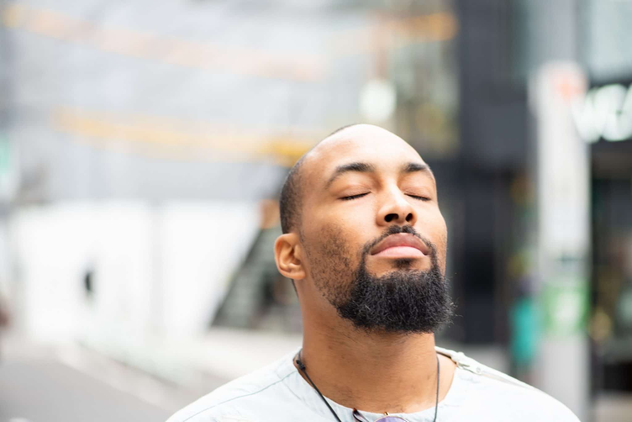 Man standing peacefully with eyes closed