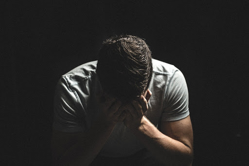man with face in hands