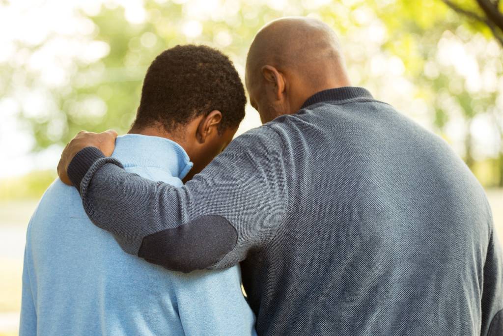 Father with arm around son