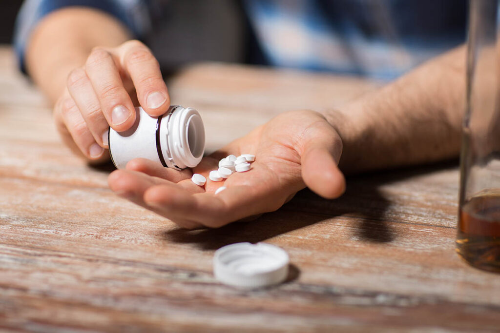 a man takes medications and wonders about the signs of prescription drug abuse