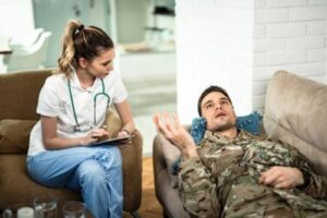Veteran lays on couch and talks to health professional during a veterans addiction treatment programs
